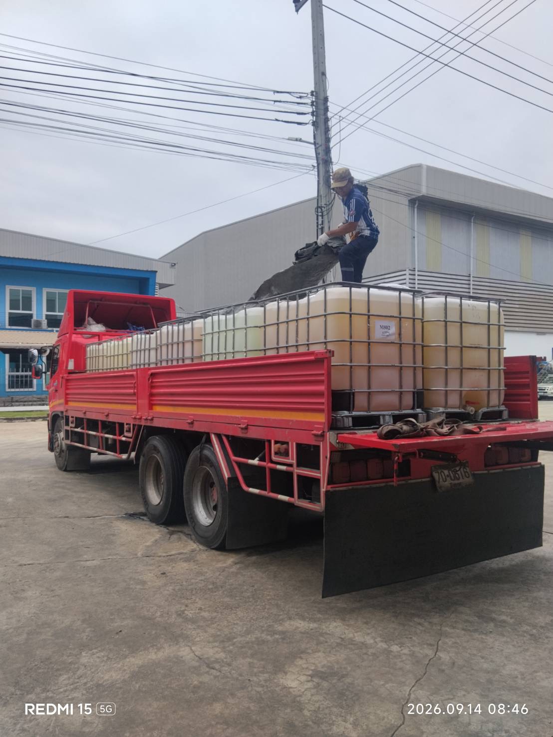 Liquid product containers being loaded onto a delivery truck